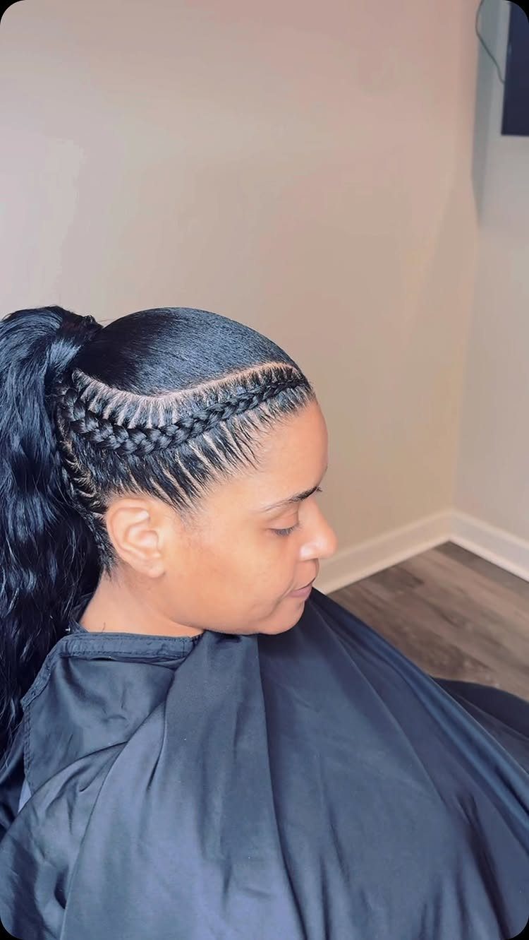 Side profile showing curved cornrow braids gathered into a sleek ponytail