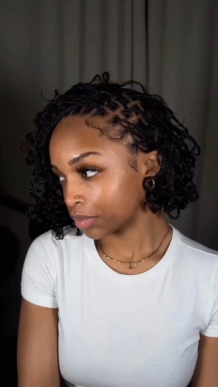 Woman displaying short layered black braids styled into a bob haircut