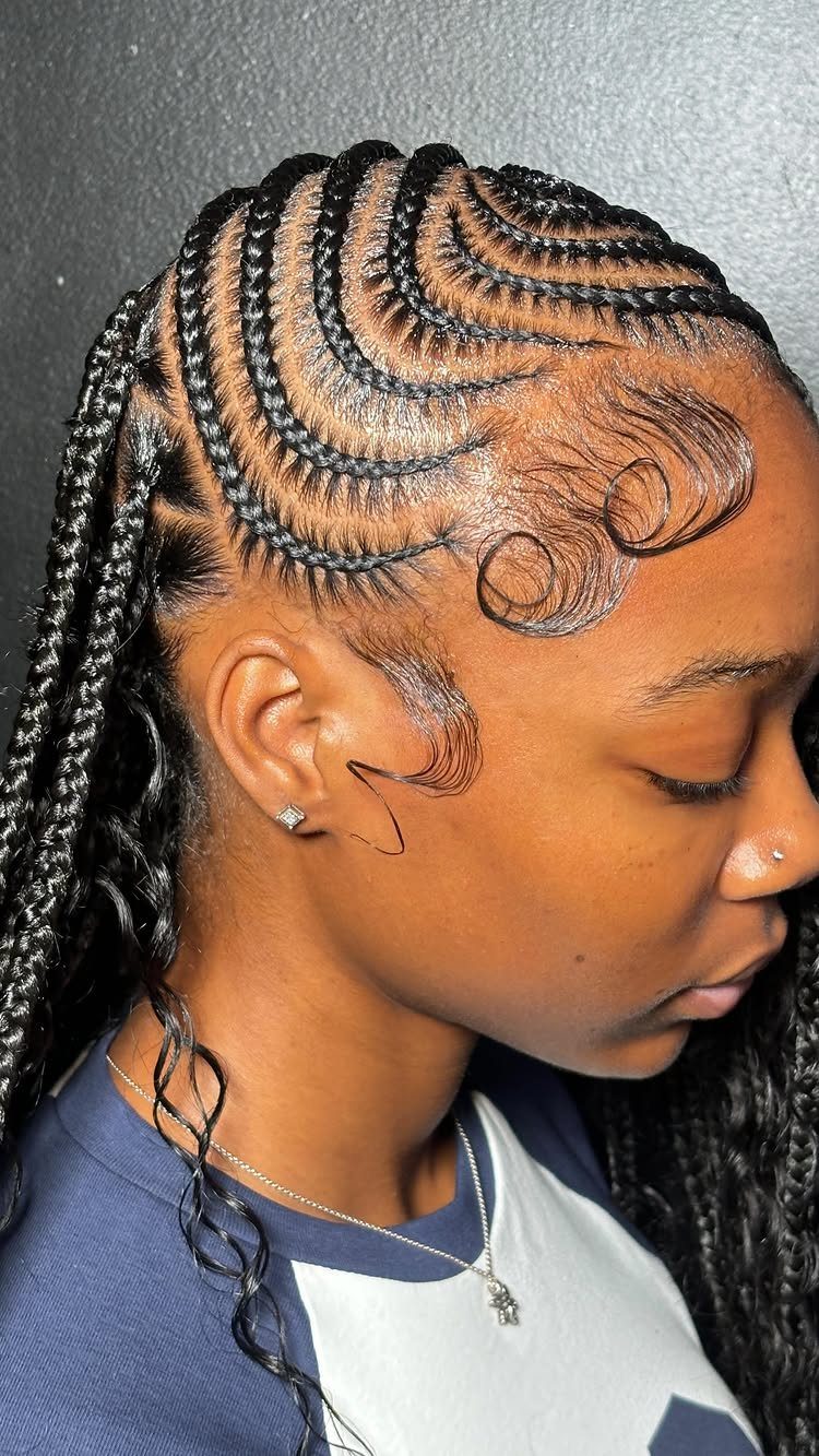 Side-profile person showing neatly swept cornrow braids extending into long braids