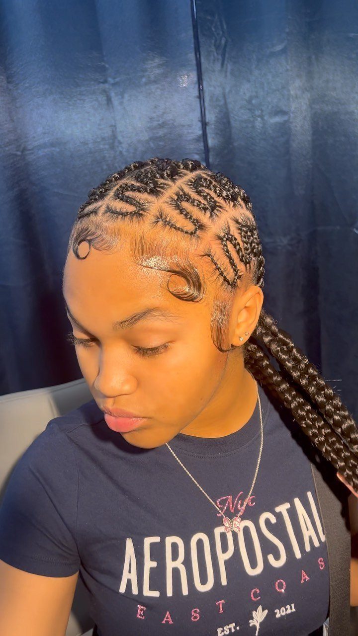 Snake-pattern cornrows curve across the scalp and continue into long braids