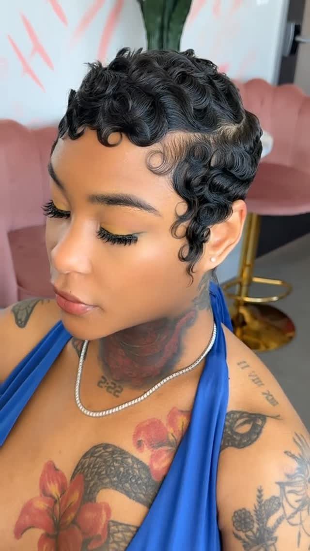 Short black hair styled in sculpted finger waves with curled edges