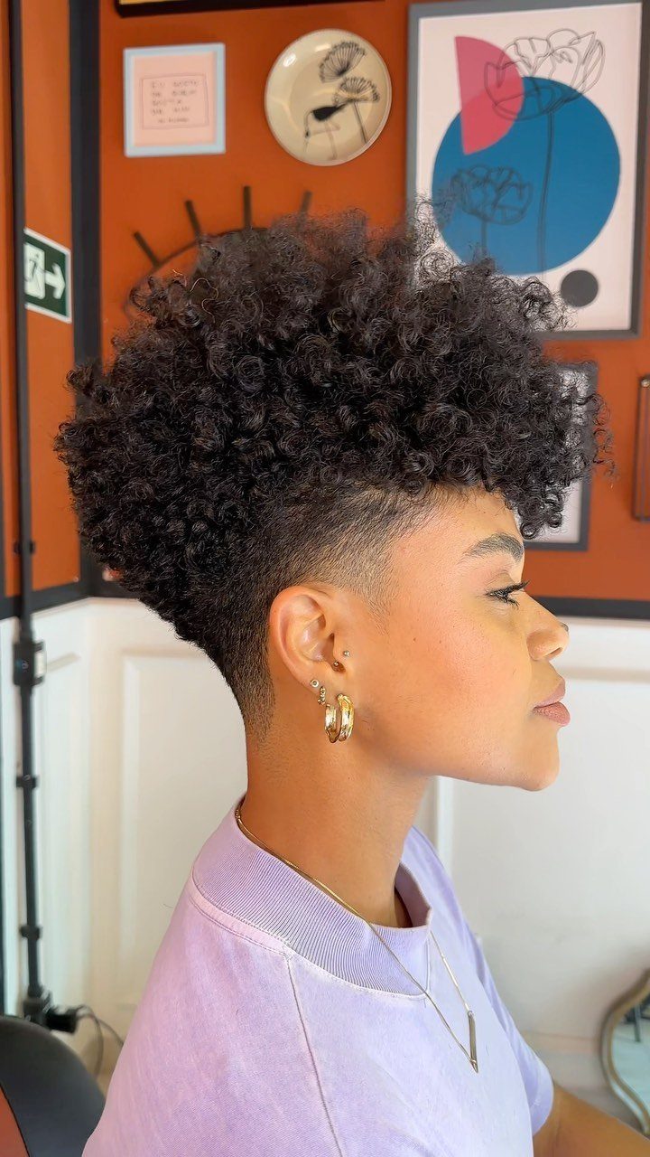 Tapered curly cut with voluminous curls on top and closely cropped sides