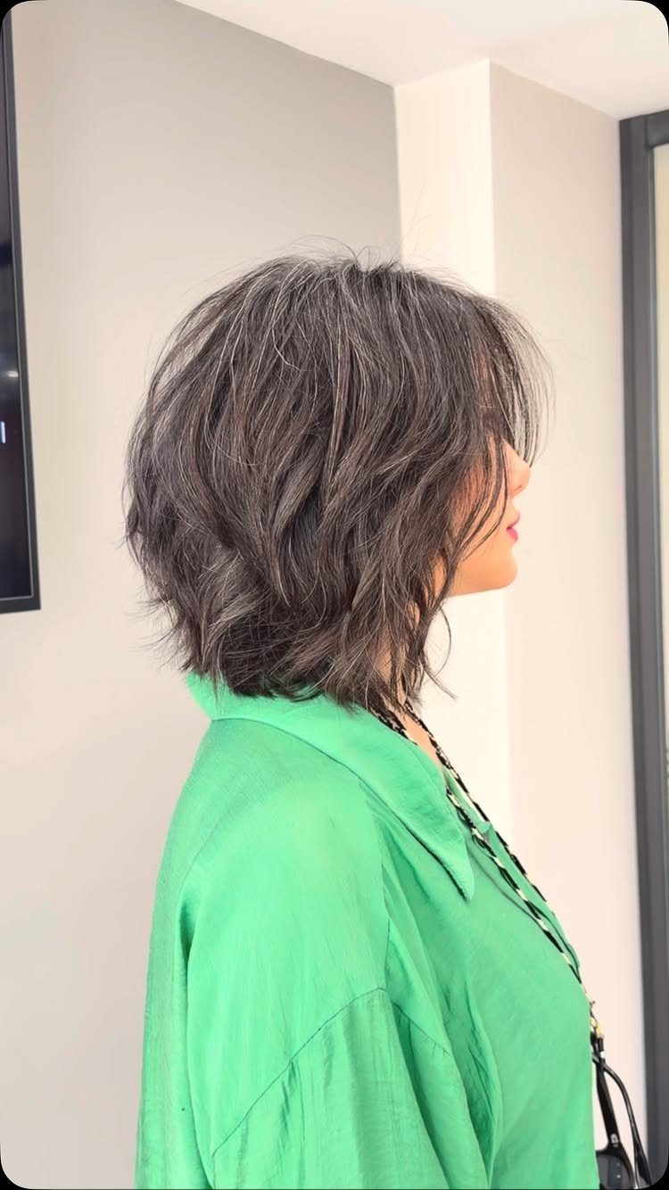 Side profile showing a shaggy wavy long bob with layered tousled ends