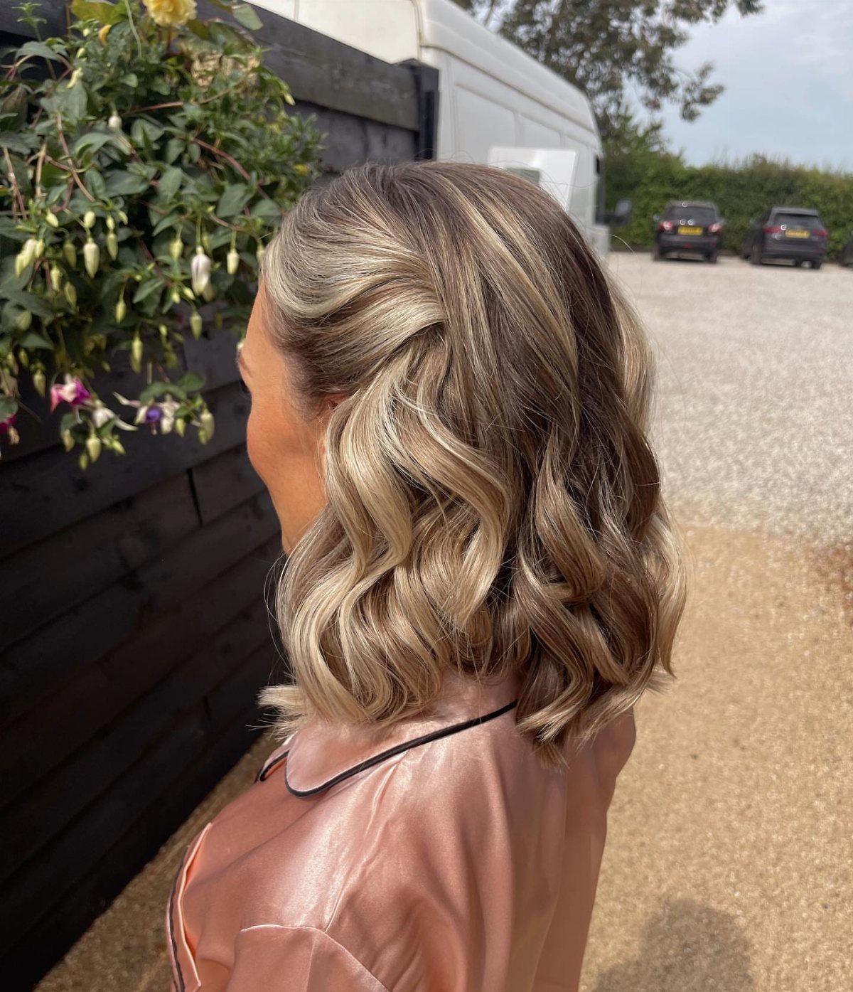 Shoulder-length blonde and brown waves styled on a person outdoors
