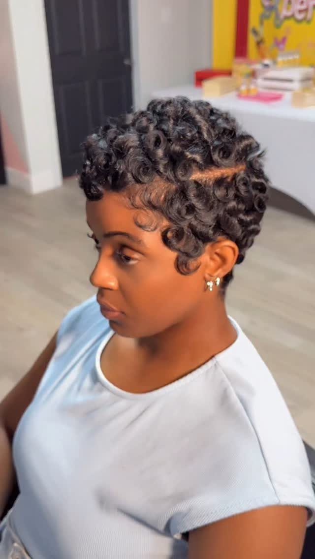Short curly pixie cut with longer curls on top and close sides