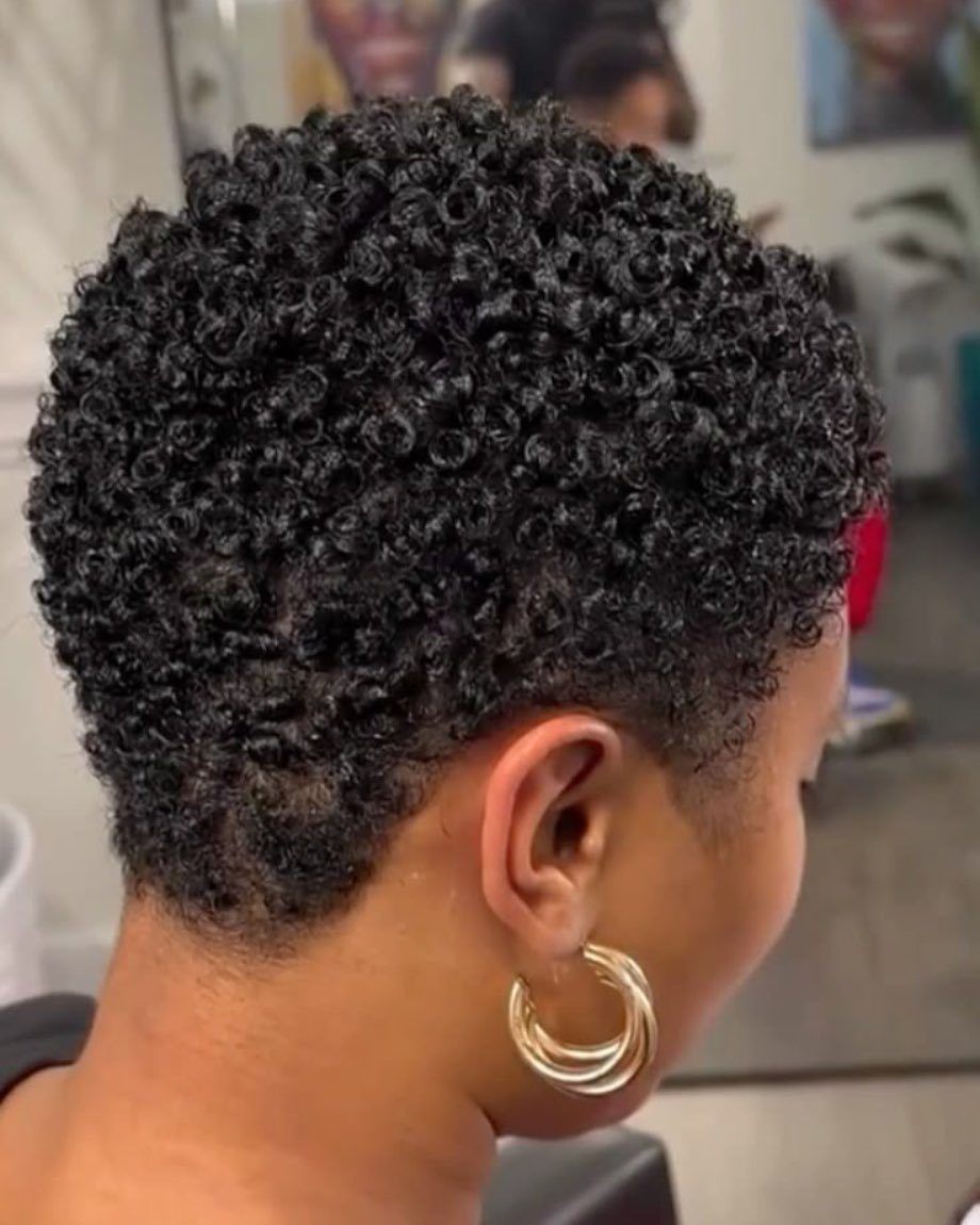 Short natural crop with dense black curls and closely trimmed sides