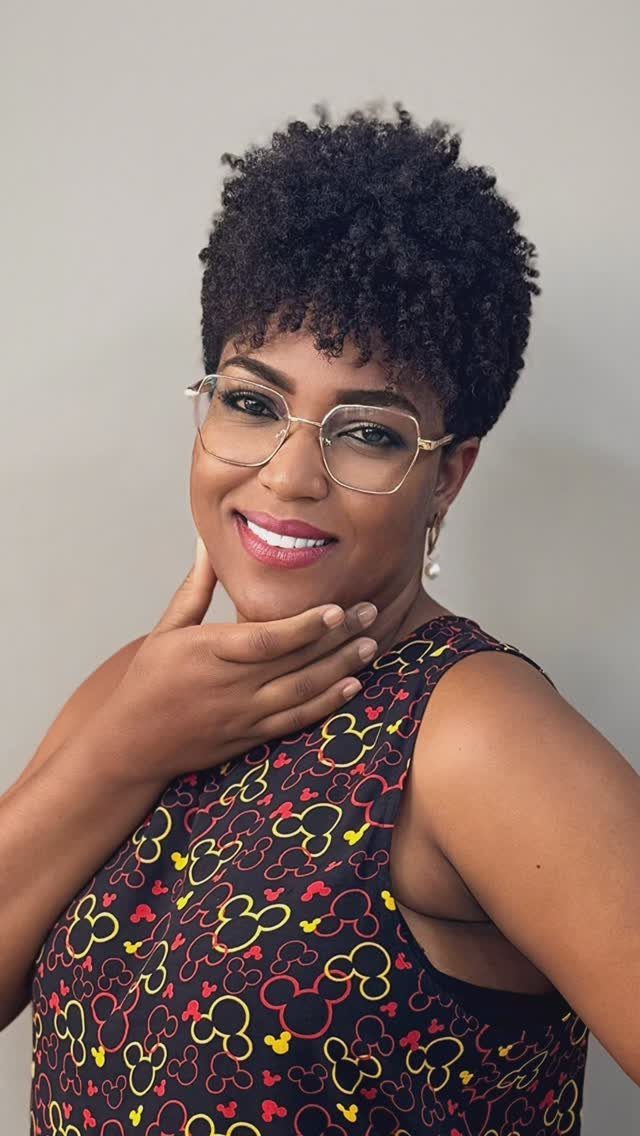 Woman posing with a short rounded afro of tightly curled black hair