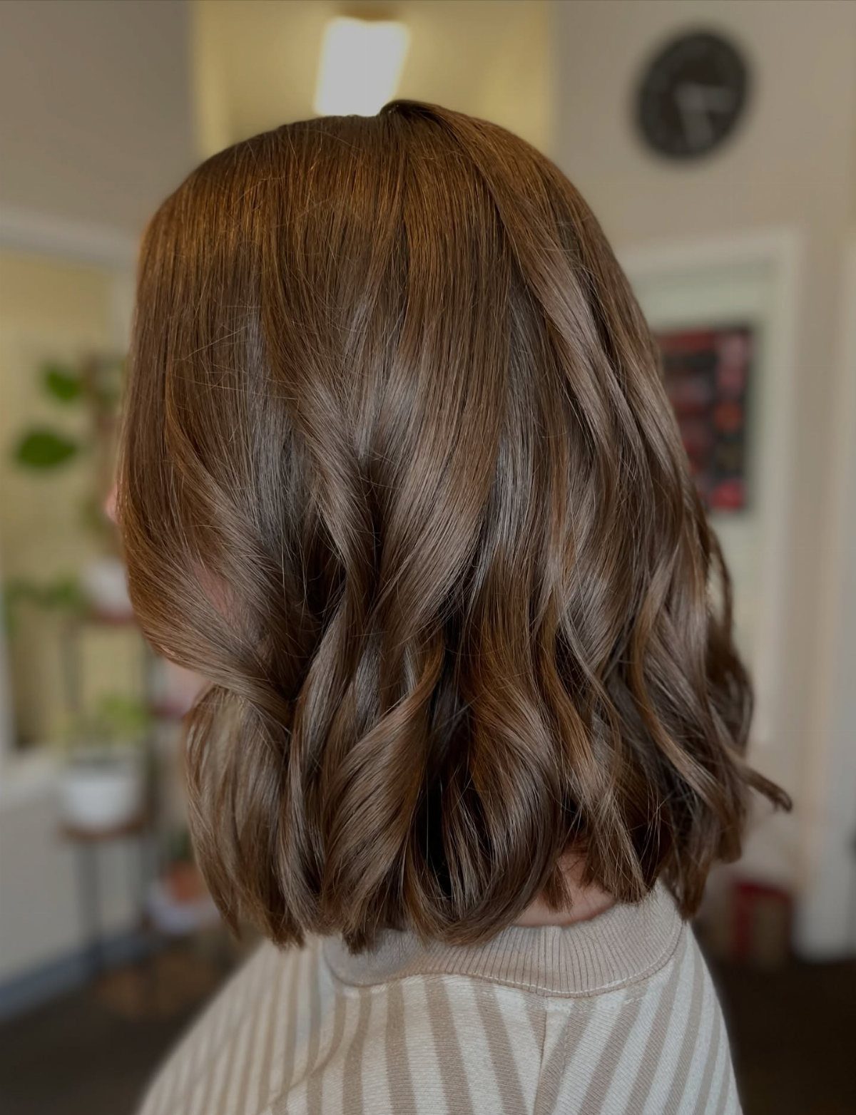 Shoulder-length brown bob with loose, textured waves shown from behind