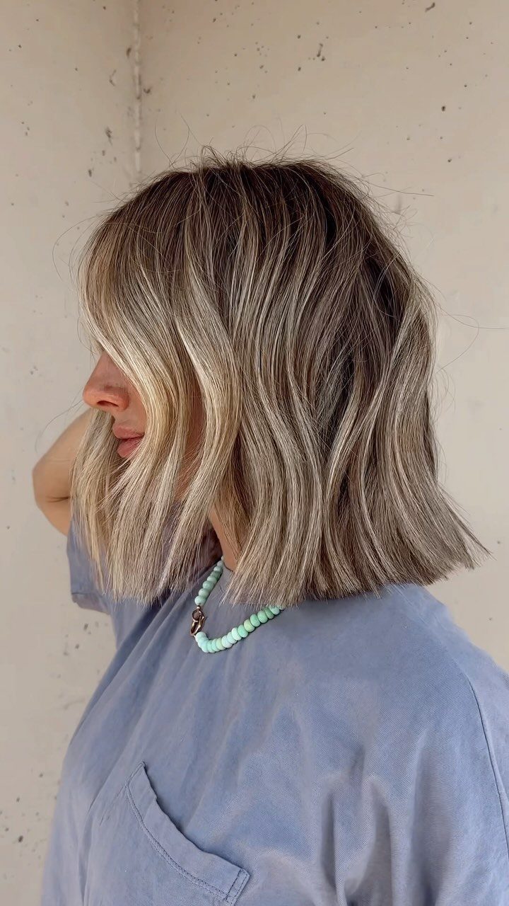 Wavy blunt bob with blonde highlights, shown in side profile