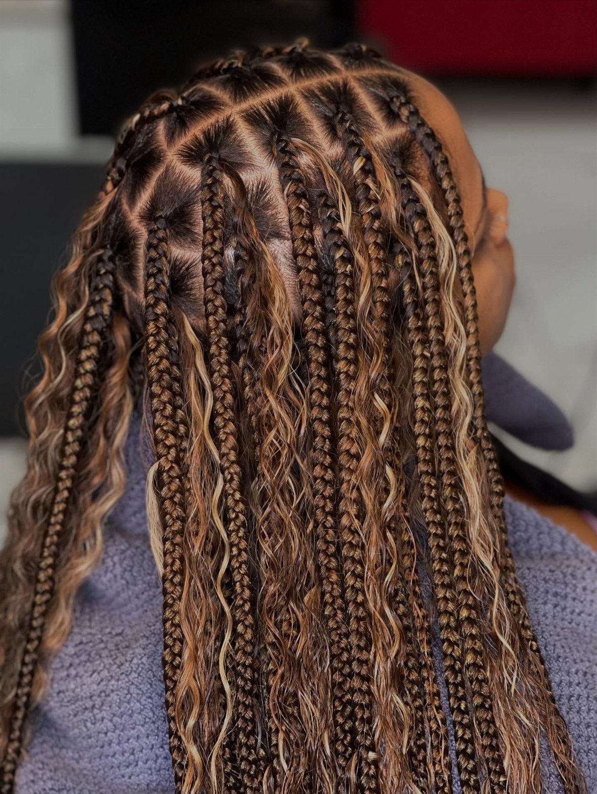 Long brown and blonde boho braids with loose wavy strands