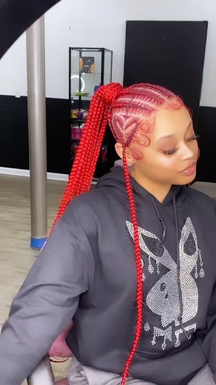 Red box braids gathered into a high ponytail with patterned scalp braids