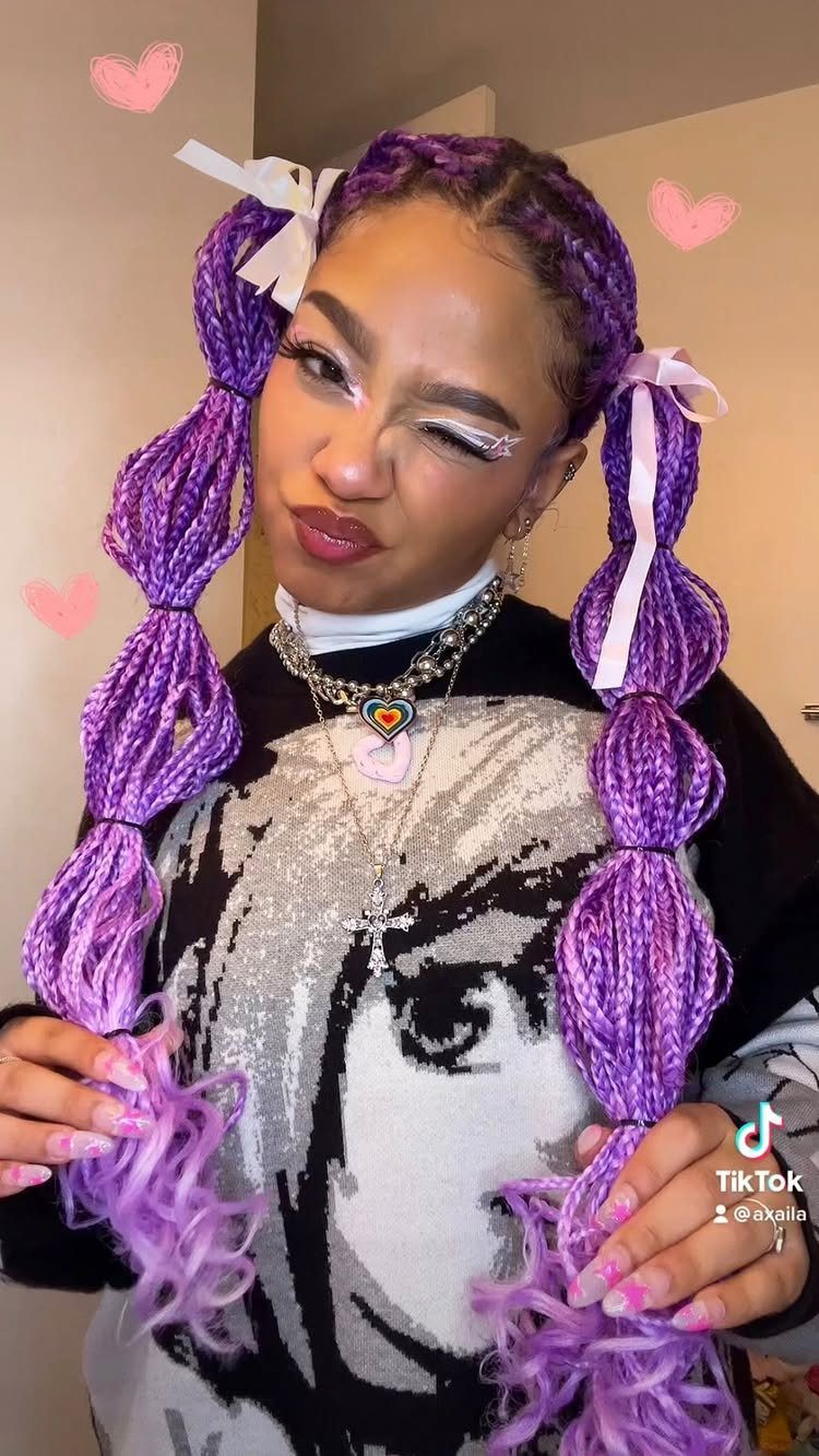 Person posing with bright purple segmented box braids and curled ends