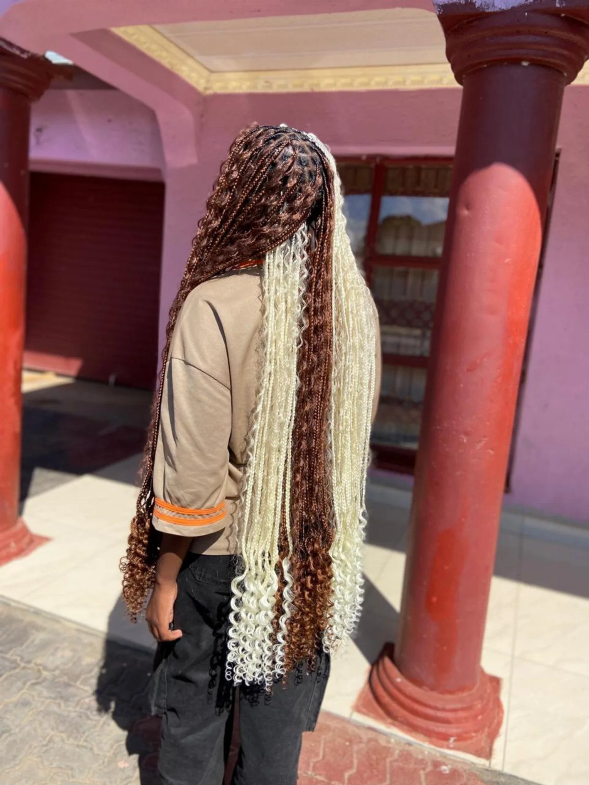 Long dark brown and pale blonde braids with curled ends