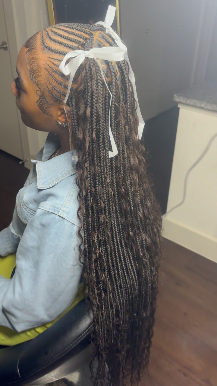 Long dark Didi braids with curved scalp cornrows and white ribbons