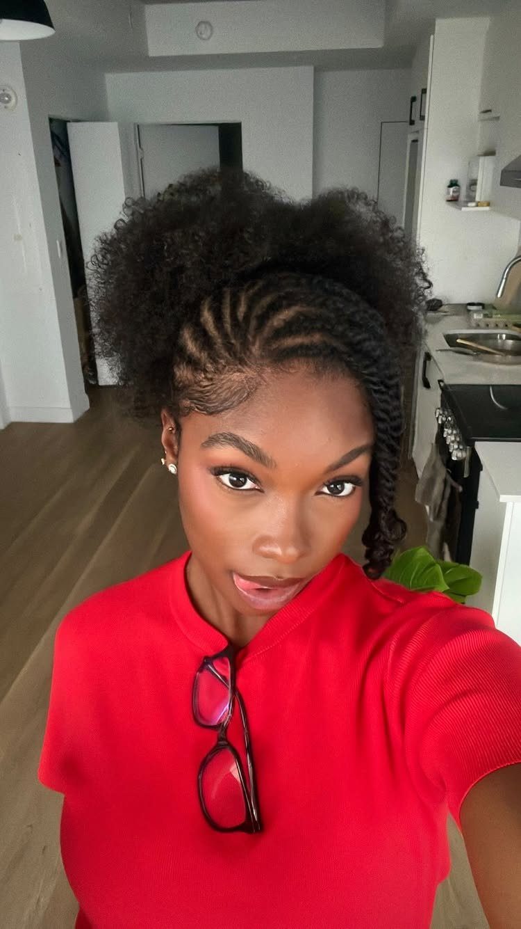 Woman with front flat twists and a voluminous natural curly puff