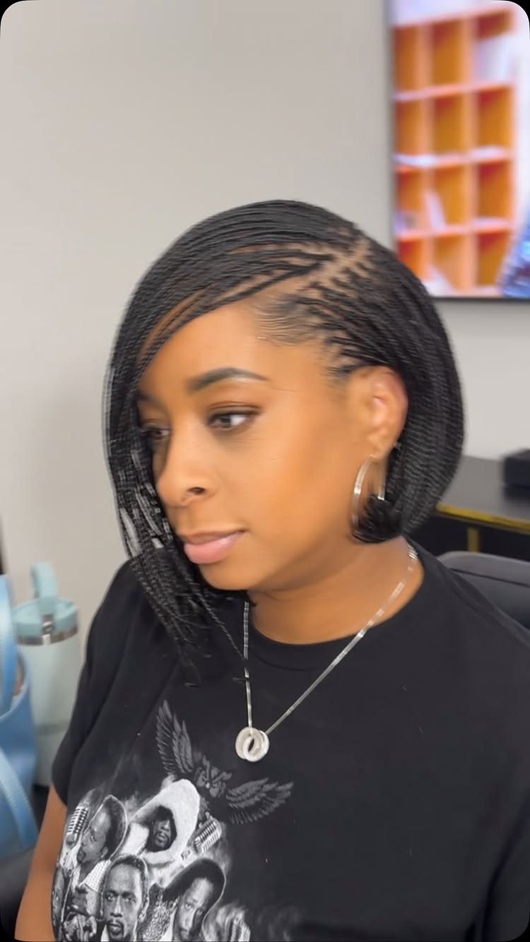Woman displaying a short braided pixie hairstyle with swept-over top braids