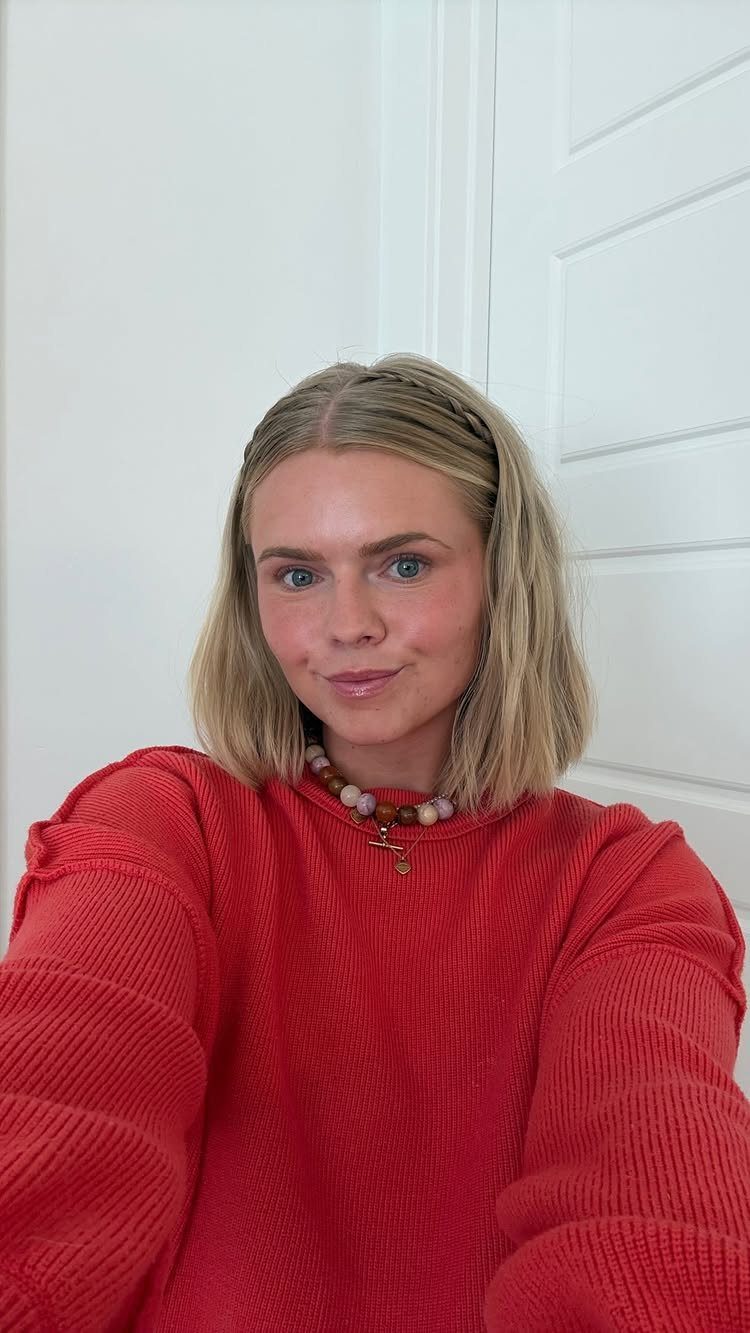 Blonde woman wears a narrow braid across her head like a headband
