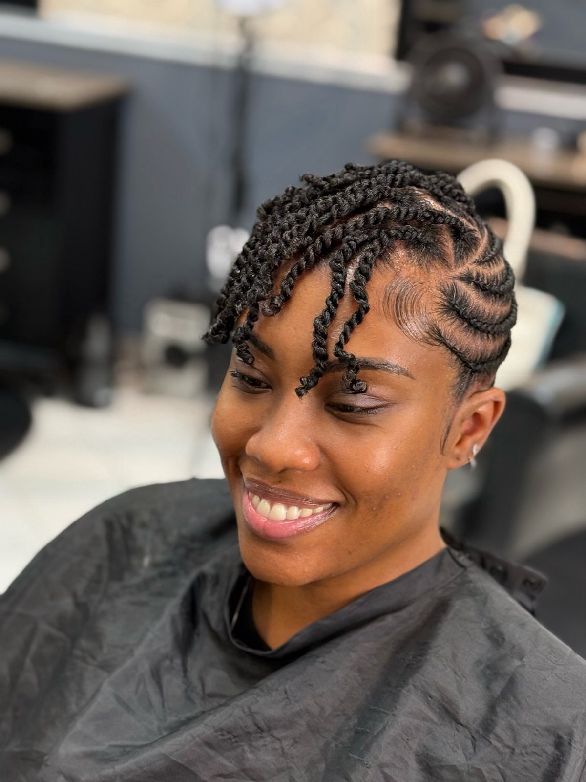 Woman showing a faux hawk updo made from neat natural hair flat twists
