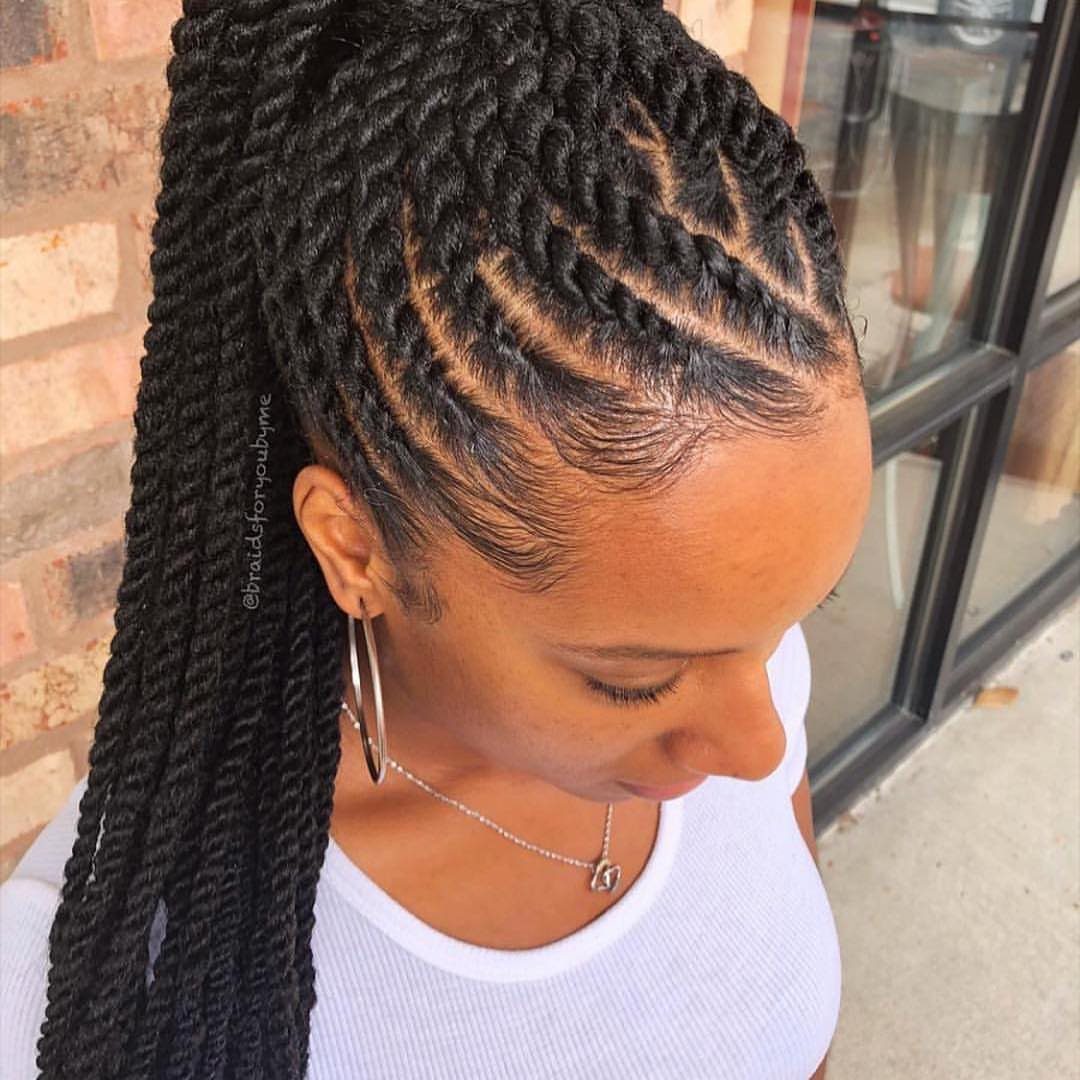 Woman displaying long twists gathered high into a ponytail with neat front twists