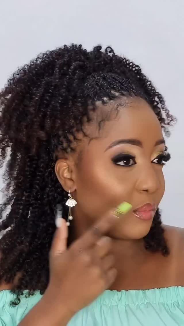 Woman showing spring twists gathered into a half-ponytail with loose curls