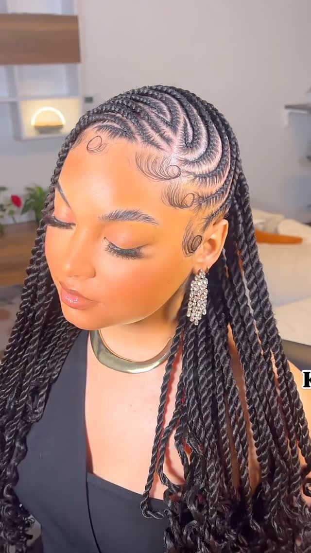 Woman displays long black twists with heart-shaped scalp cornrows and curled edges