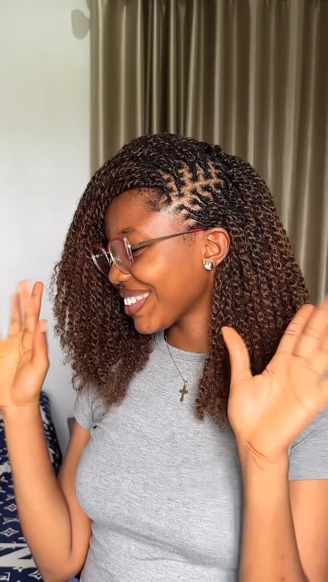 Woman smiling and showing long, detailed mini twists with a patterned part
