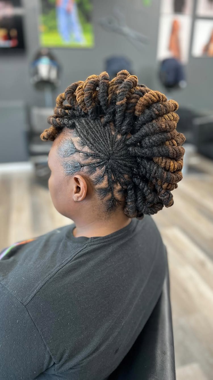 Mohawk hairstyle with cornrows and chunky twists styled on a seated person