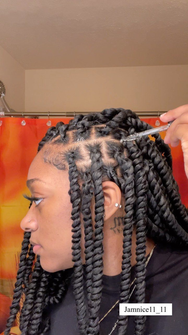 Woman with long black passion twists and neat scalp partings