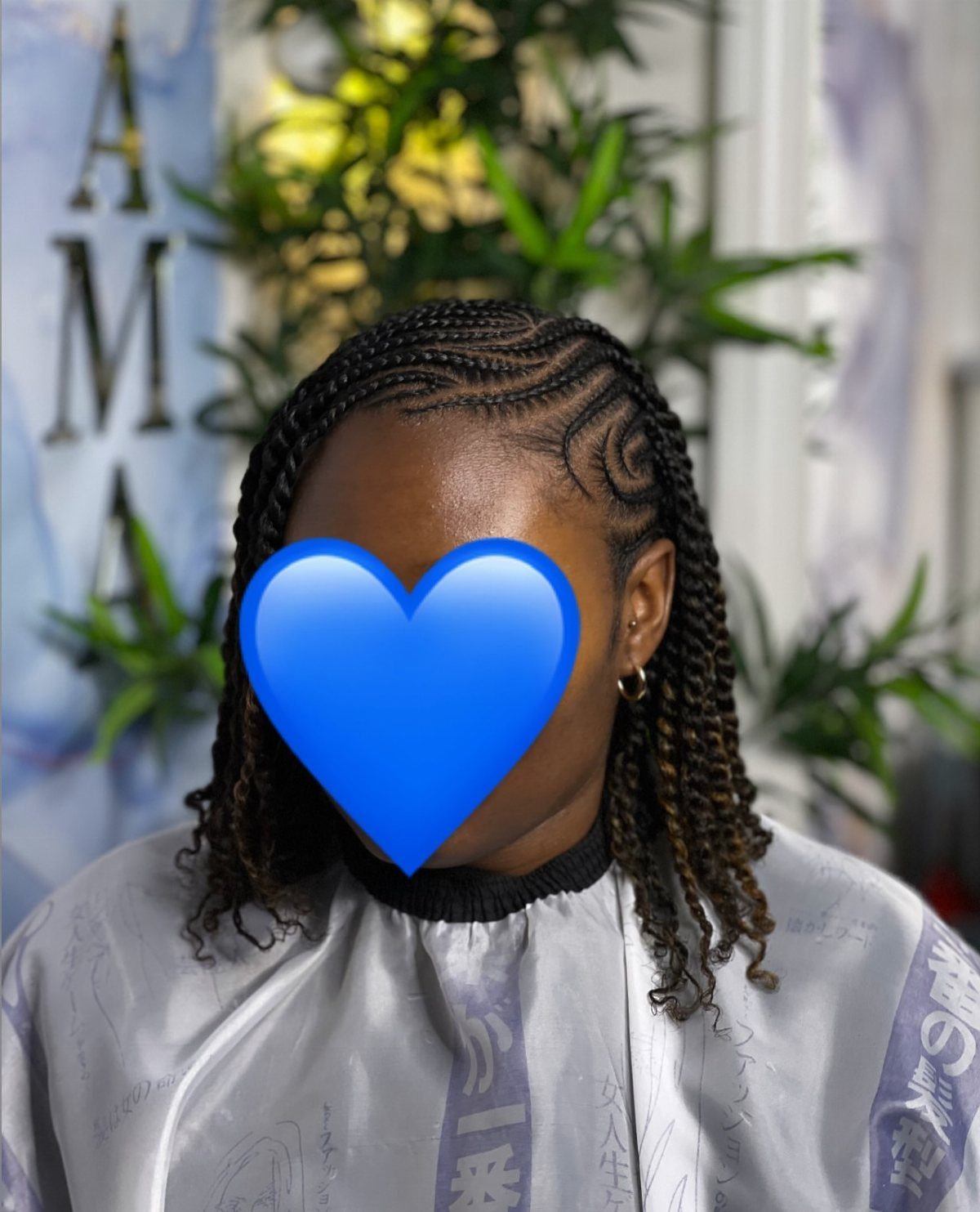 Side-swept dark twists with scalp cornrows and curled ends