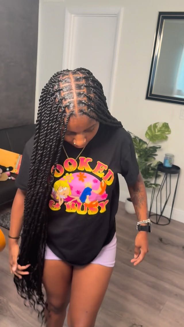 Woman displaying long, polished black Senegalese twists with clean scalp partings
