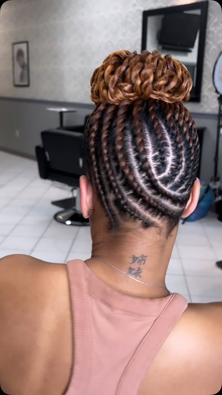 Curved scalp twists gathered into a large honey-brown twisted bun
