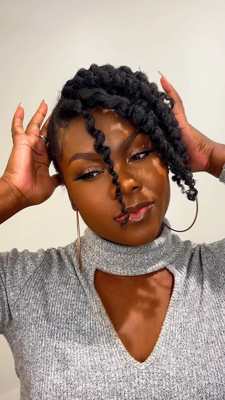 Natural black twists gathered on top with loose twists framing the face
