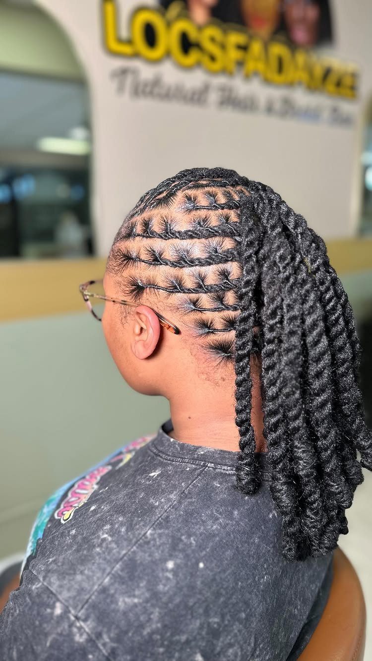 Scalp braids lead into thick twists hanging down the back