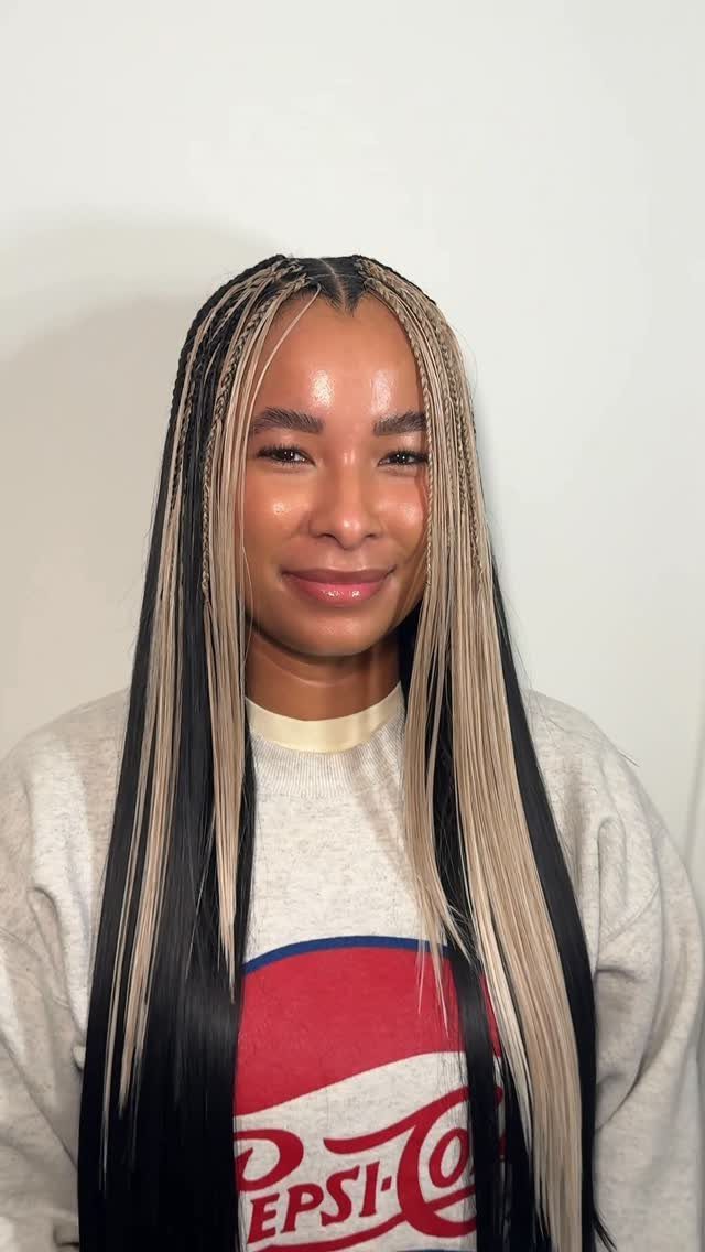 Woman with long, thick black and blonde center-parted box braids