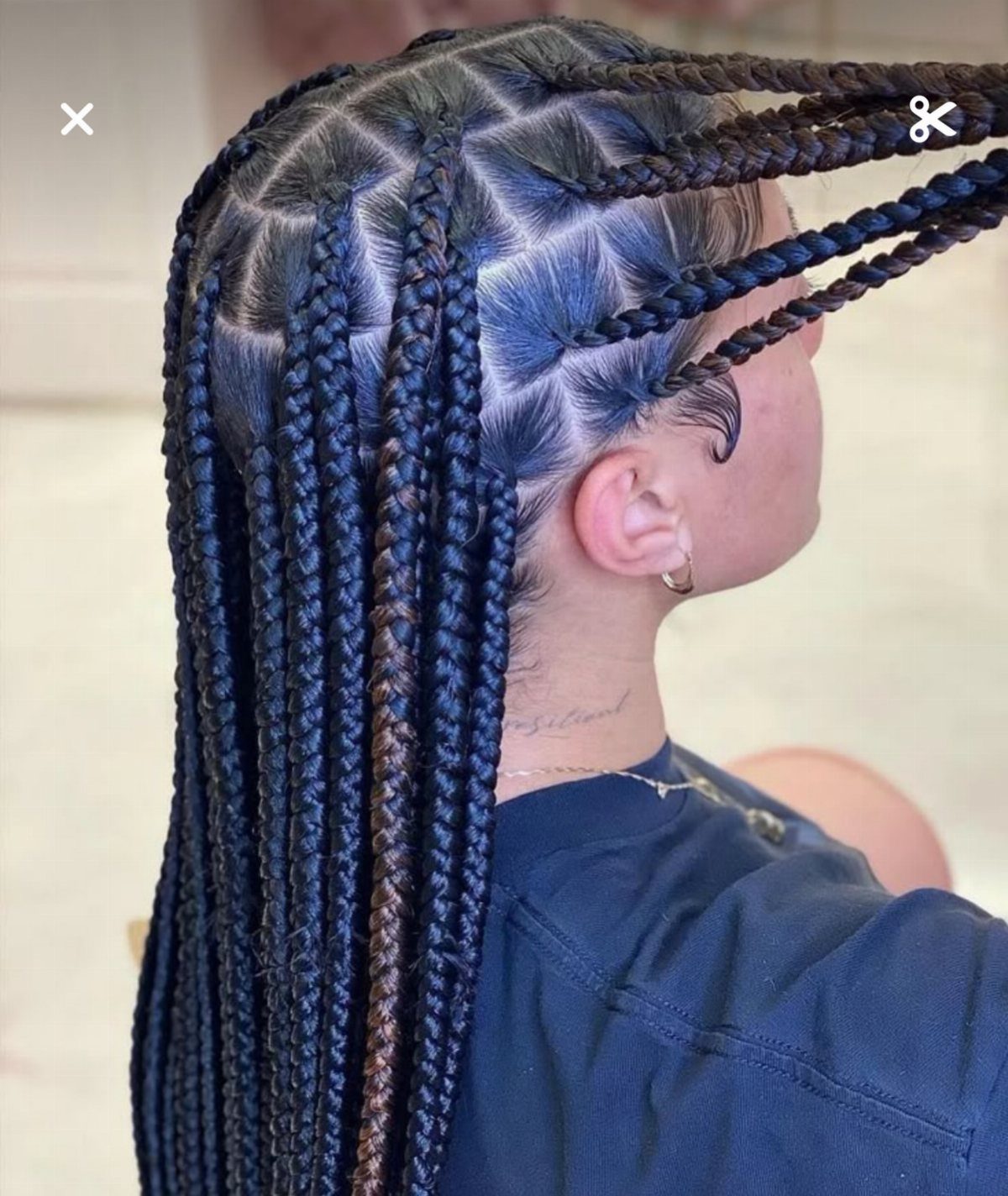 Long black box braids with a few lighter brown strands and neat scalp partings