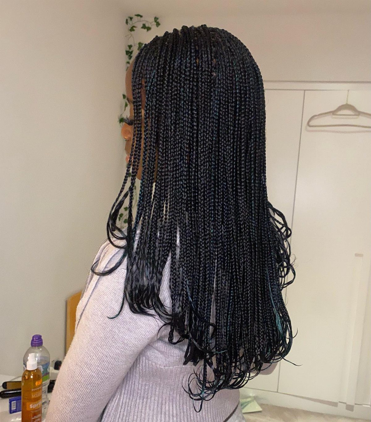 Layered black box braids with varying lengths and loose wavy ends