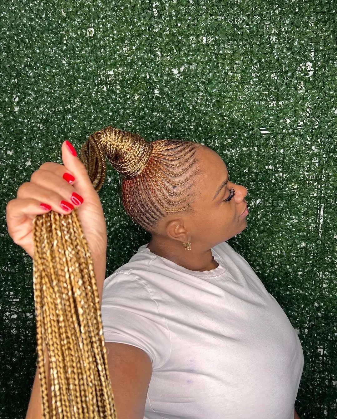 Woman displaying a high ponytail of long blonde box braids with neat scalp rows