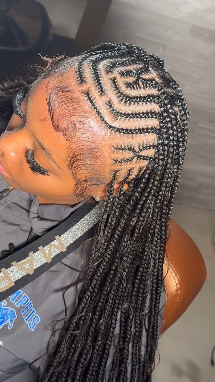 Intricate tribal box braids with curved cornrow patterns and long braided lengths