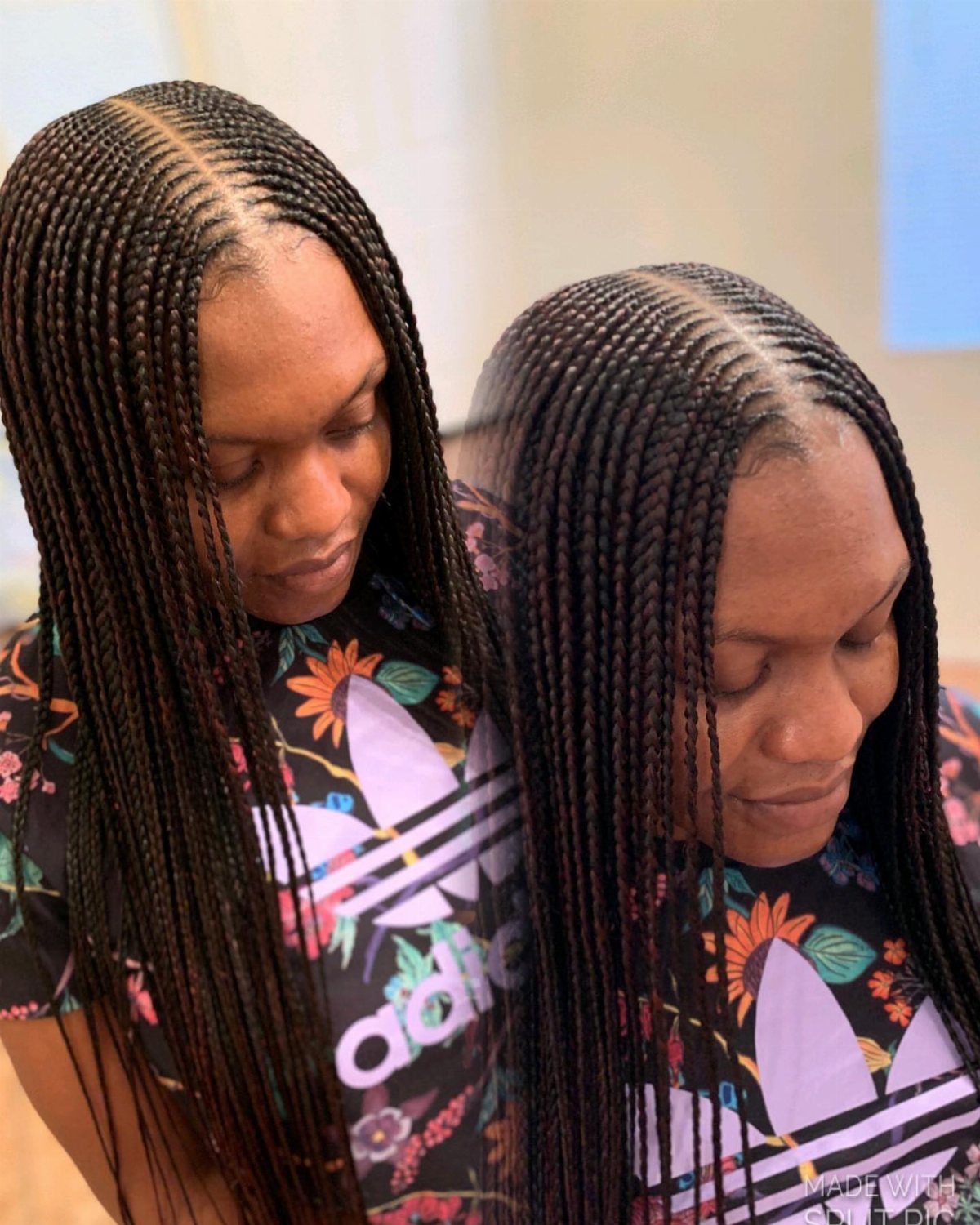 Two women display long, dark box braids with neat middle parts