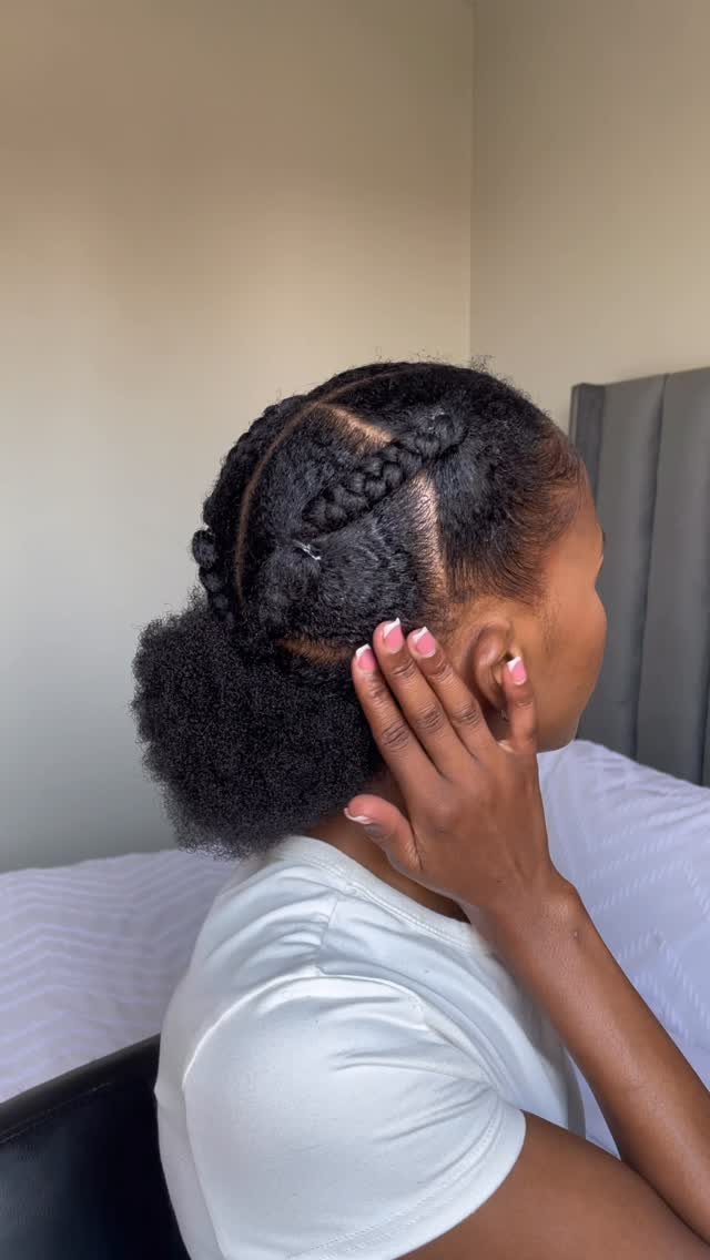 Braided bun gathered at the back of a woman's natural hair