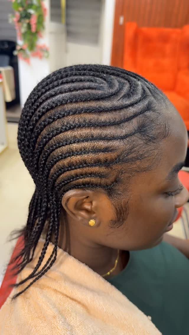 Cornrows curve in neat rows across a person's scalp and hang behind the head.