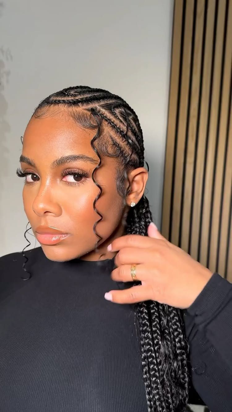 Woman wearing glossy jumbo cornrows with long braids and curled tendrils