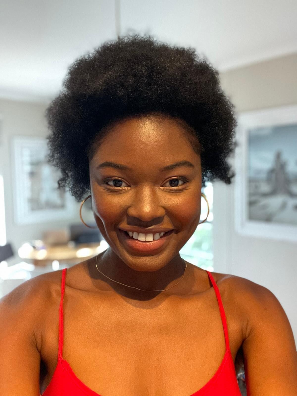 Woman wearing her natural hair in a short, full afro