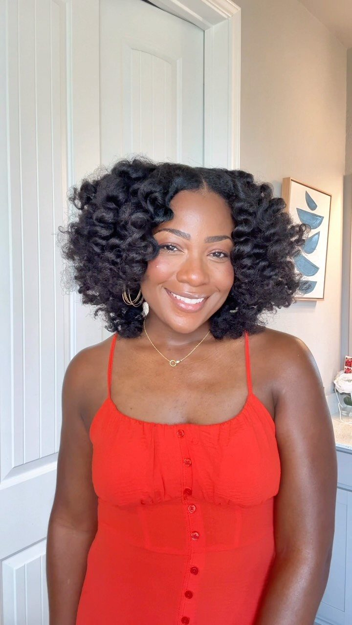 Woman showing voluminous loose curls from a Bantu knot-out hairstyle