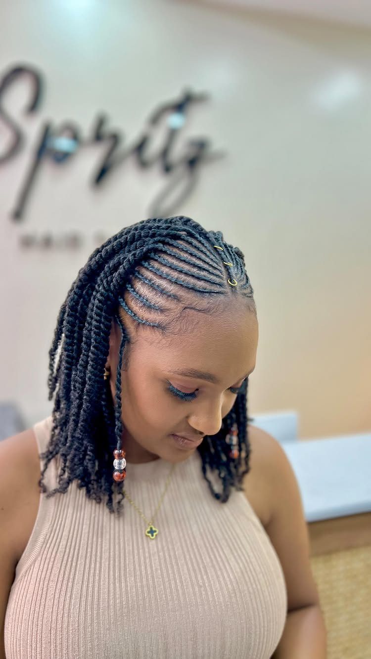 Woman with neat cornrows braided closely along her scalp into long braids