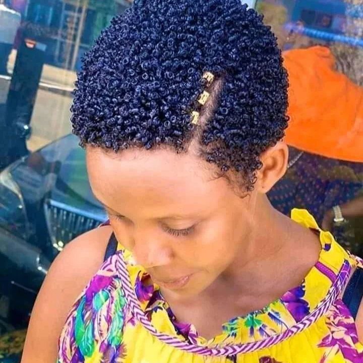 Short defined curls with gold clips along a narrow side part
