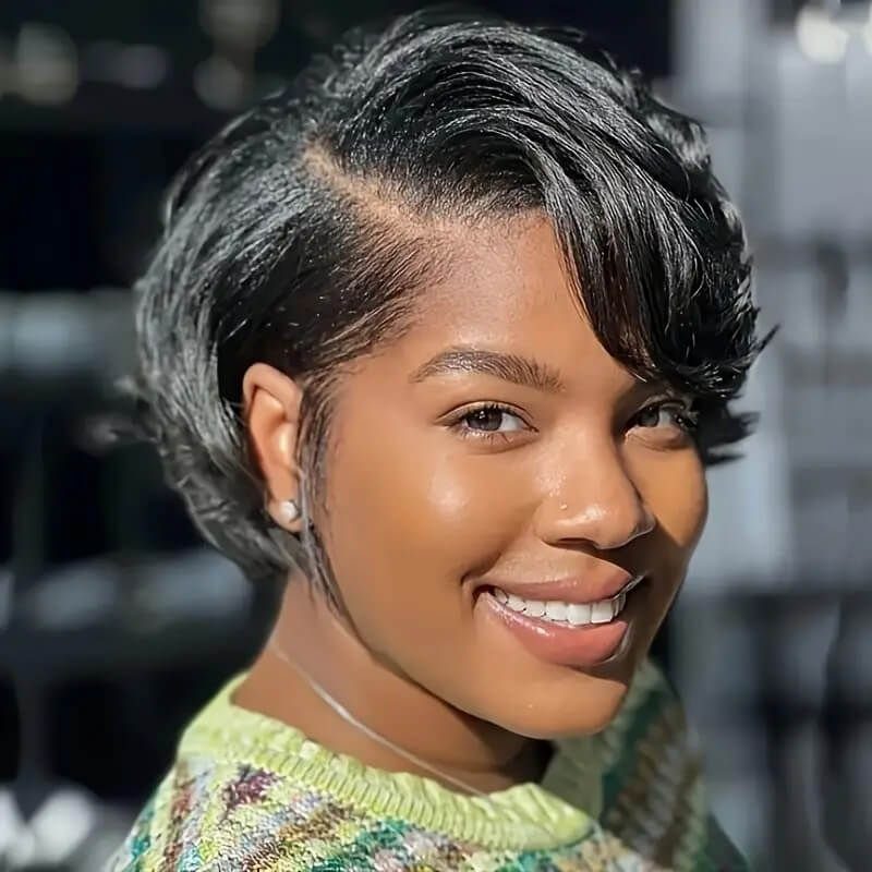Woman wearing a short, glossy pixie cut with a deep side part