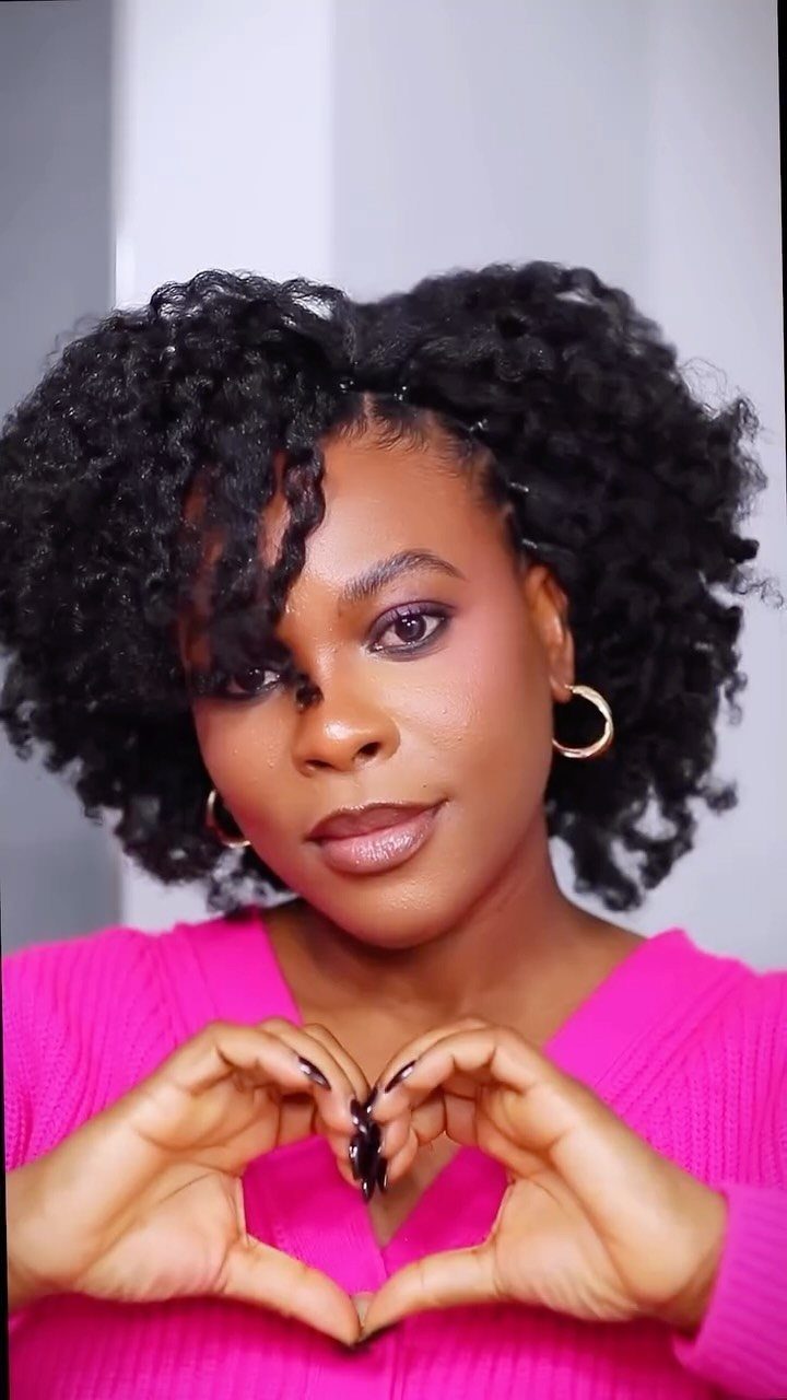 Woman showcasing voluminous defined twist-out curls with loose twists framing her face