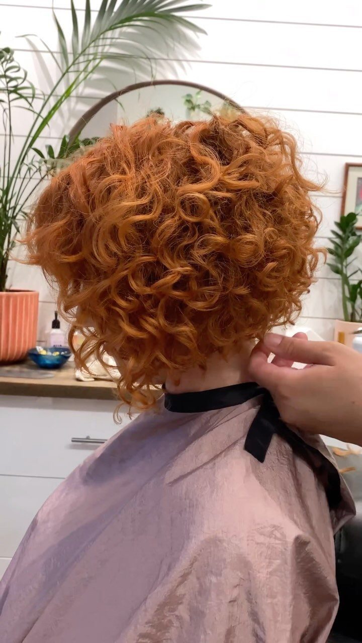 Copper curls fill the back of a salon client’s head