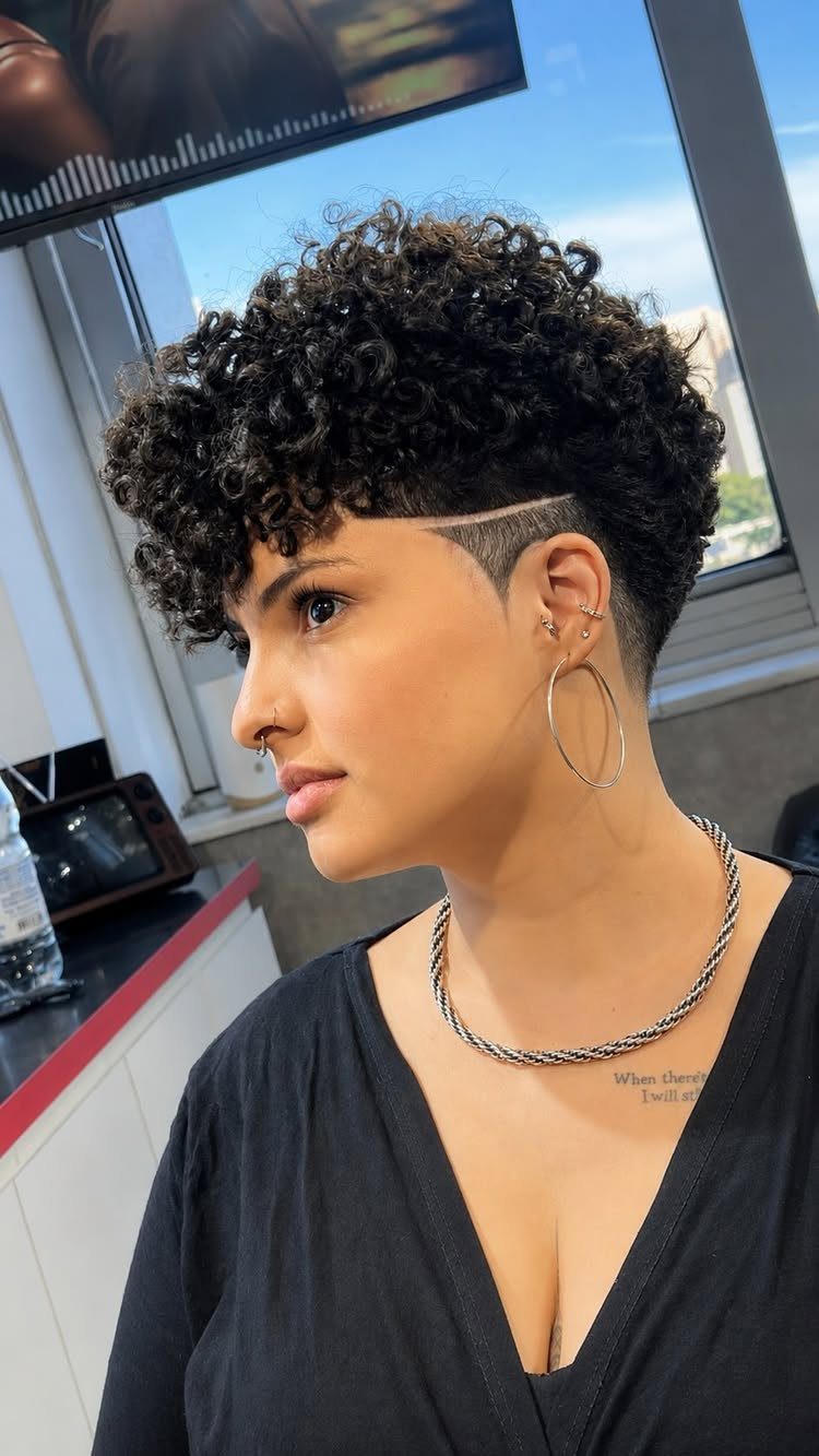 Short defined ringlets with tapered sides and a shaved line above the ear